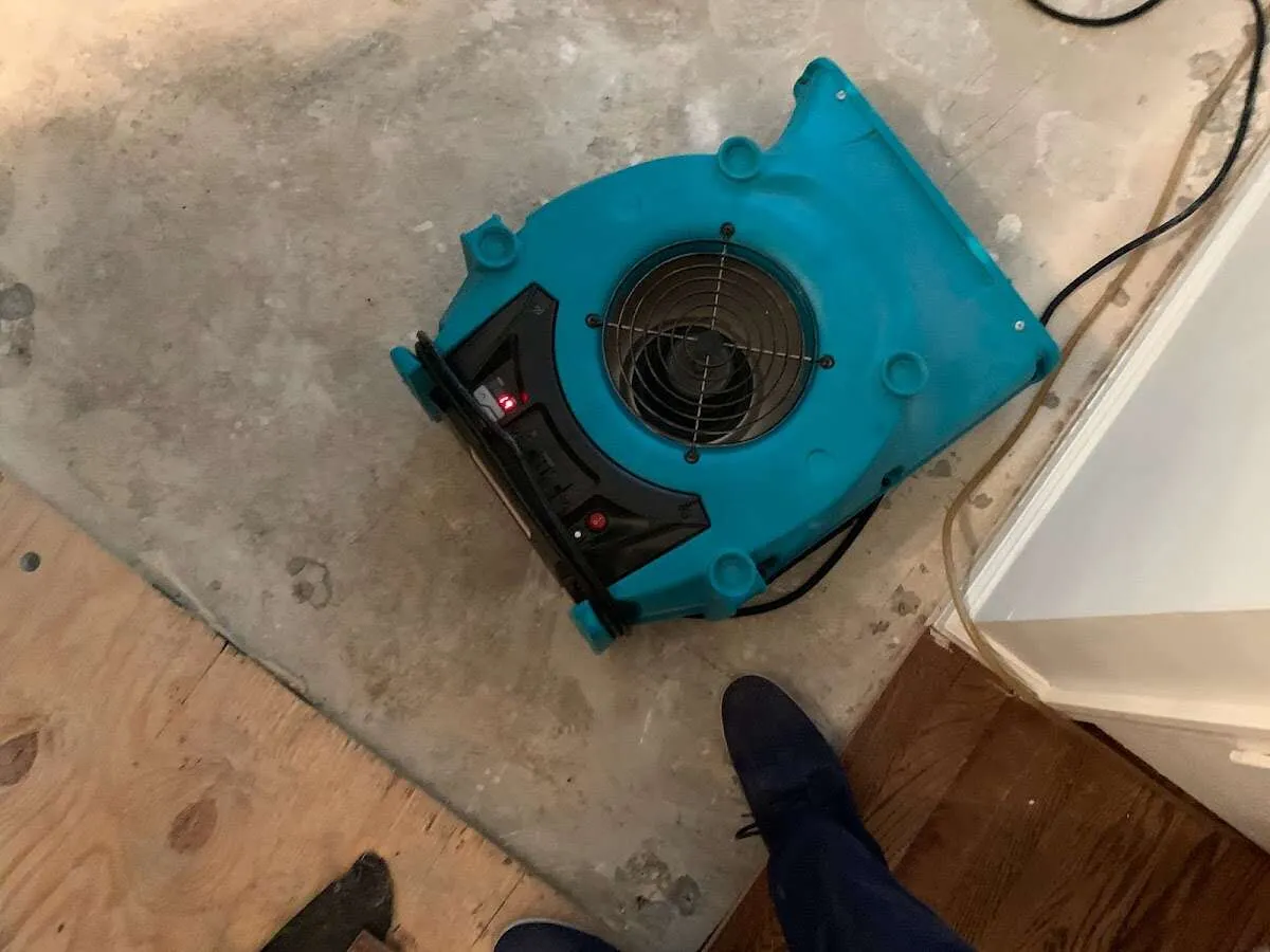 Air mover drying subfloor during Commercial Water Damage Restoration in Walker